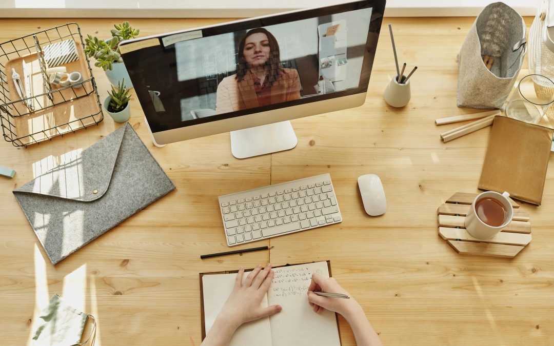 A computer screen with a woman on a zoom call.